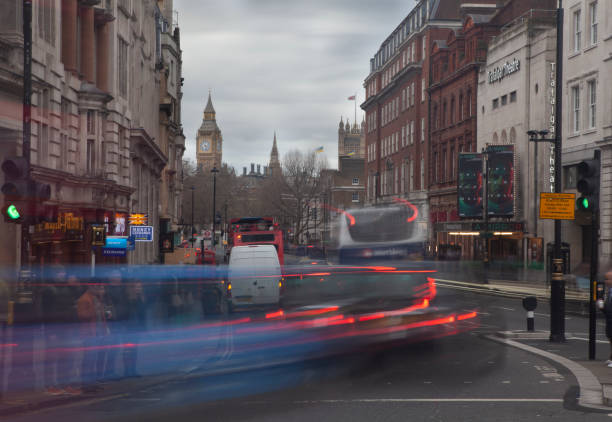Busy Whitehall road crossing, with motion blur London busses and taxis