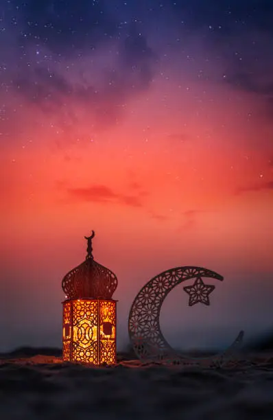 Photo of Crescent moon shape and lantern lamp on the beach