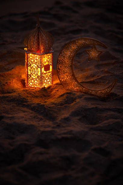 istock Ramadan lantern with crescent moon on the beach sand 2018100338
