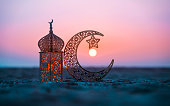 Ramadan Kareem photography, Lantern with crescent moon shape on the beach