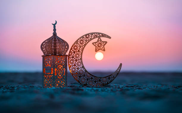 Ramadan Kareem photography, Lantern with crescent moon shape on the beach Ramadan Kareem photography, Lantern with crescent moon shape on the beach with sunset sky, 2024 Eid Mubarak  greeting background eid lantern stock pictures, royalty-free photos & images