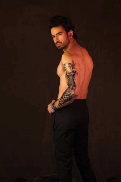 istock A stylish shirtless man posing in style with tattoo on hand 2018112359