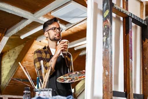 Young painter in his art studio