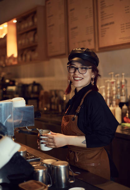 istock A barista prepares coffee for a customer in the cafe where he works. 2018133088