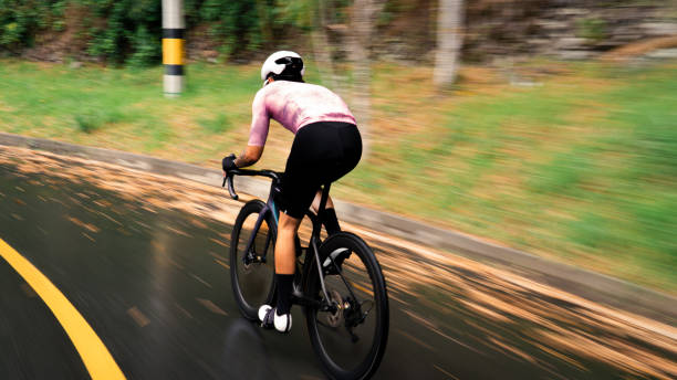 istock cyclist riding down a hill very fast. Dynamic and inmotion bacground 2018171232