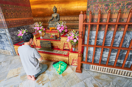 Image material of a monk praying at a Buddhist altar