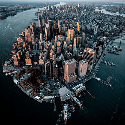 An incredible scene of the Lower Manhattan seen from a helicopter perspective during blue hour.