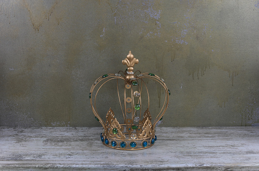 golden crown on a wooden table
