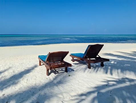Beach loungers on the dream white beach of the Maldives