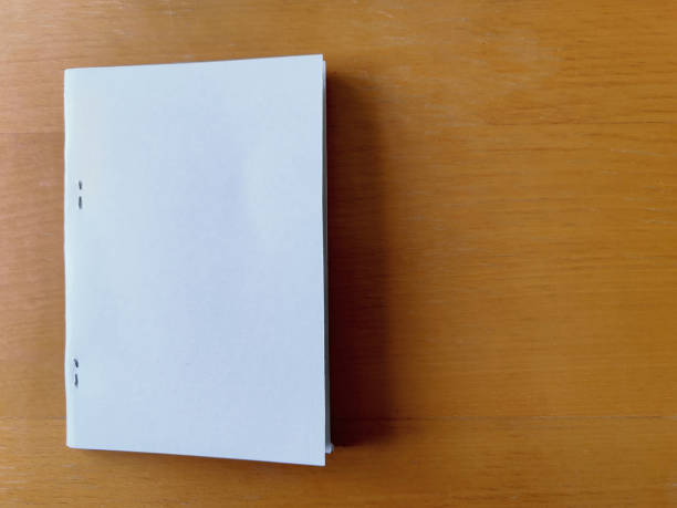Paper documents are stacked on a wooden table at the workplace.Business concept.
