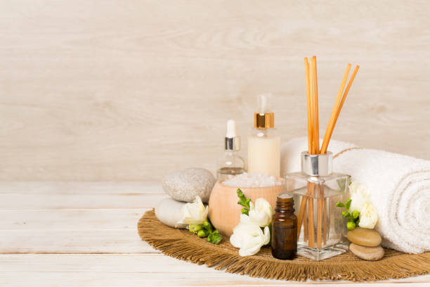 istock Spa composition with freesia flower and aroma diffuser on wooden table 2018444489