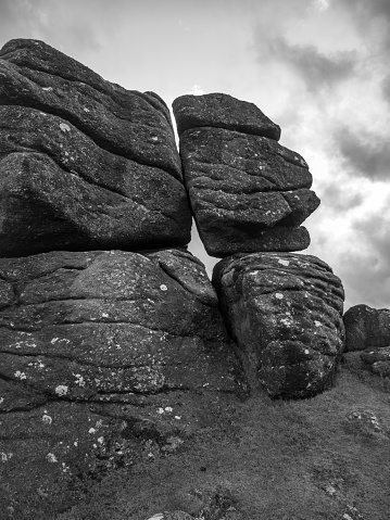 A monochrome image of a rock formation at Bonehill Rocks, Dartmoor National Park, Devon.