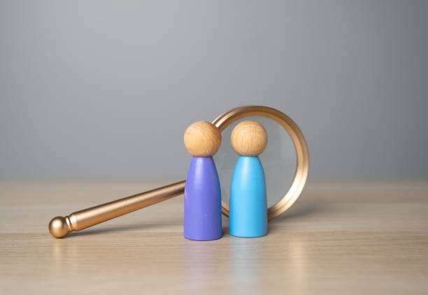istock Two people and a magnifying glass. Figures of people. Human resources. Headhunter. Recruiting, staffing. Hiring best talented professional candidate for a vacant job position. Employment agency 2018475671