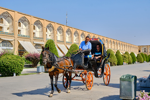 Isfahan , Iran-June 30, 2023: Naqshe Jahan Square, iran isfahan. Touristic horse carriage at square.