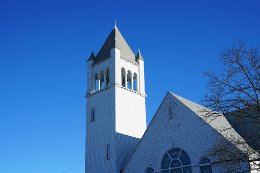 Part of an old church with deep blue sky behind.