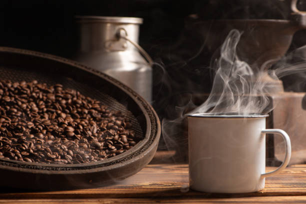 Coffee, white coffee mug on rustic wood and accessories, dark background, selective focus.
