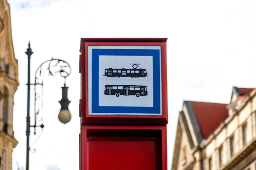 Prague, Capital City of Prague - Czech Republic - 09-18-2022: Informative sign depicting tram and bus symbols against Prague's urban backdrop