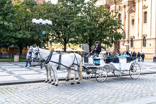 Prague, Capital City of Prague - Czech Republic - 09-18-2022: A horse-drawn carriage offers a historical mode of transport through Prague's streets