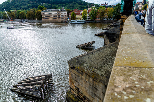 Prague, Capital City of Prague - Czech Republic - 09-18-2022: Observing life and architecture along the Vltava River from Charles Bridge, Prague