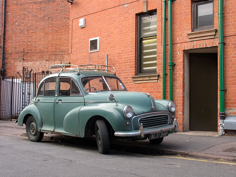 Leicester, United Kingdom – 9th November, 2006: Classic Morris Minor vehicle (1948–1971) on a street. This model was the one of the most popular British cars in history. It was the first British car to sell over a million units.