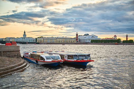 Ships moored to the stone bank of the Neva River. View of Vasilyevsky Island