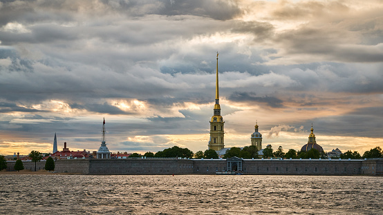 View of old Peter and Paul fortress on the bank of Neva river in the City Saint Petersburg at Sunset, Russia. Cloudy evening sky