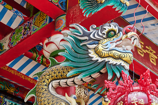 A chinese dragon carving at the Jao Mae Soi Dok Mak chinese taoist Shrine in Ayutthaya. Phra Nakhon Si Ayutthaya. Thailand.