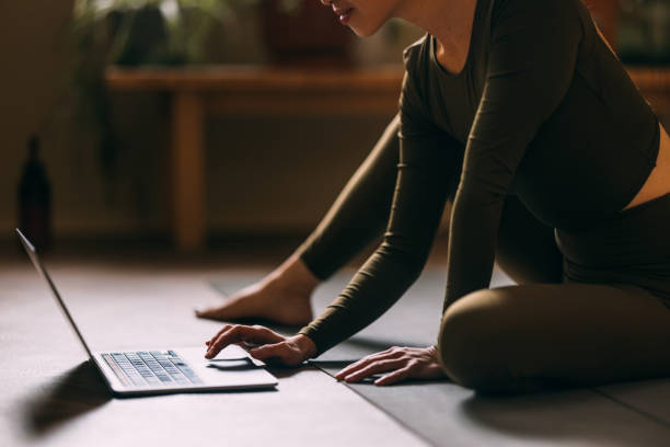 istock Woman Participating in Virtual Yoga Session 2018573085