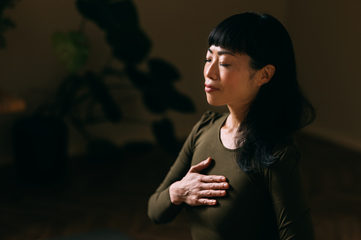 Portrait of a peaceful woman meditating with closed eyes.