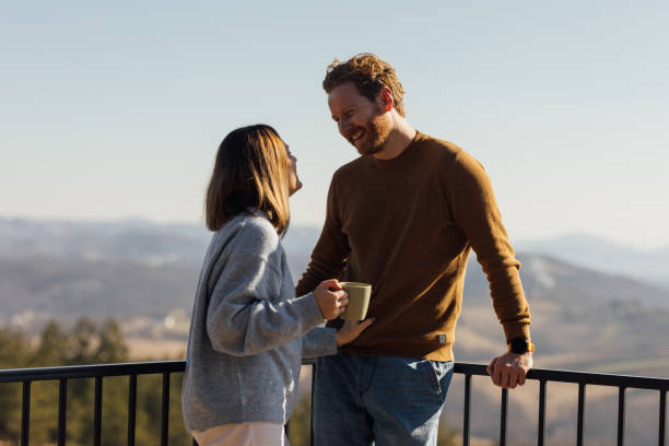 istock Affectionate Couple Enjoying Morning Coffee on Mountain Balcony 2018595117