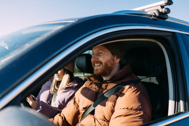 Smiling Couple Enjoying a Car Trip on a Sunny Day Together
