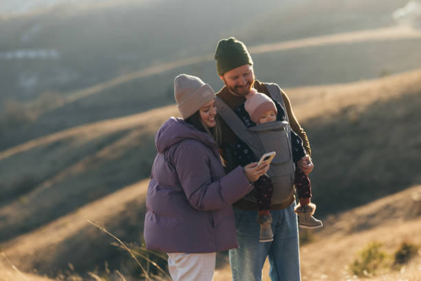 istock Young Family Enjoying a Winter Day Outdoors with Newborn 2018596201