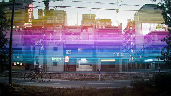 A multi colored light trail passing over a person cycling on a city street. All objects in the scene are 3D, image on billboard is my own