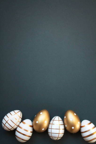 istock Happy Easter concept with elegant Easter eggs decorated with gold on dark green background with copy space 2018637140