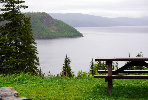 istock Picnic table overlooking the sea with forested mountains in the background on Cape Breton Island 2018650971