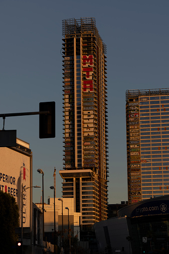 Los Angeles, California, USA - February 11, 2024: Sunset light shines on the abandoned and graffiti covered Oceanwide Plaza skyscrapers.