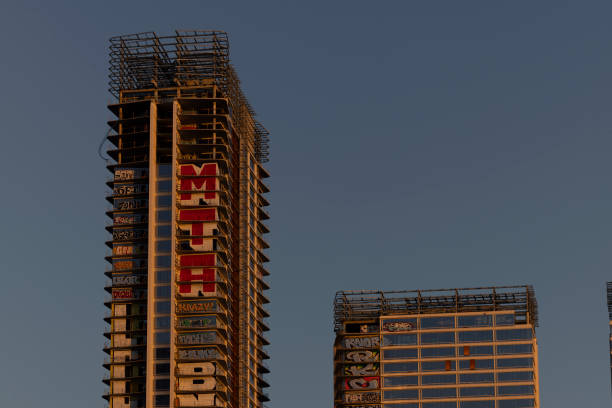Los Angeles, California, USA - February 11, 2024: Sunset light shines on the abandoned and graffiti covered Oceanwide Plaza skyscrapers.