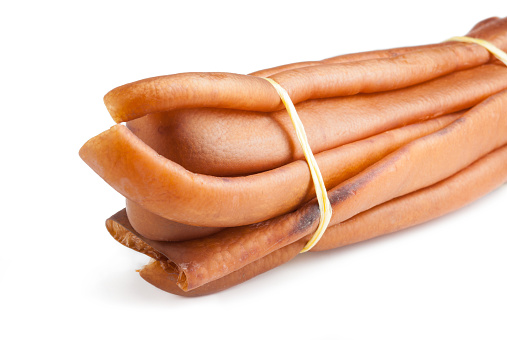 Sausages in vacuum packaging on a white background. A pack of sausages from a store isolated on a white background.