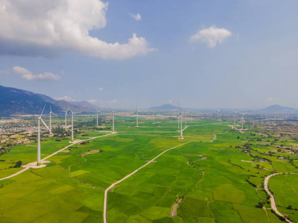 istock Wind power plant. green meadow with Wind turbines generating electricity 2018737120
