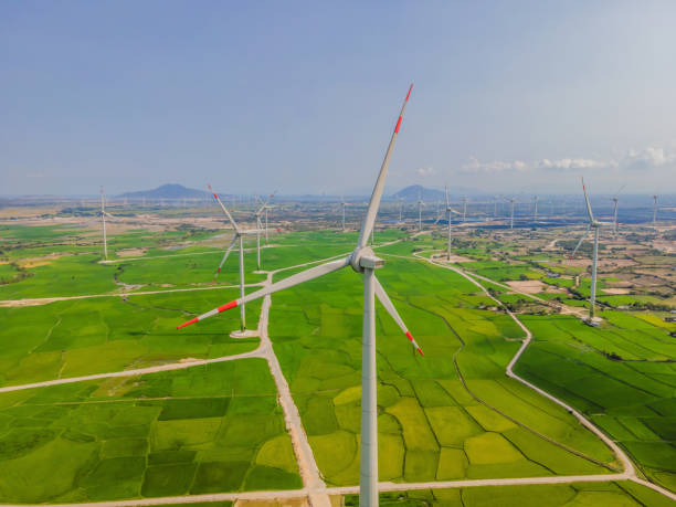 istock Wind power plant. green meadow with Wind turbines generating electricity 2018737121