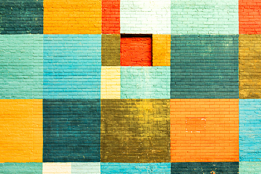 colorful old brick wall in different colors in geometric pattern