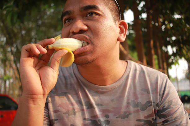 istock brown man enjoy banana 2018801060