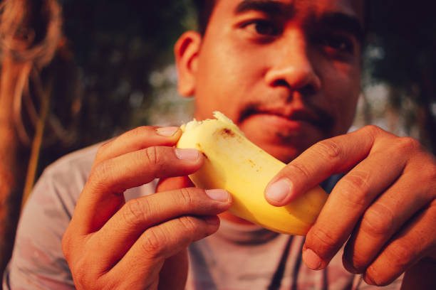 brown man enjoy banana
