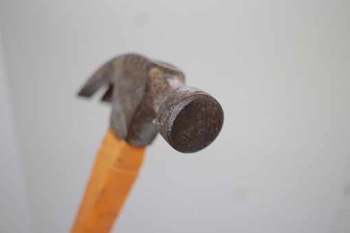 Old hammer with nails lying on boards