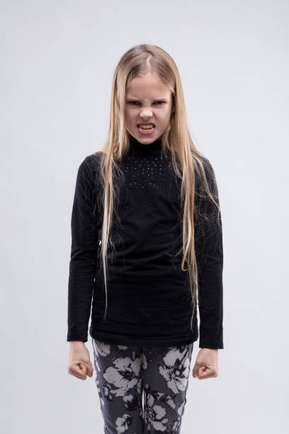 istock Girl grimaces fiercely, her frustration visibly intense 2018993259