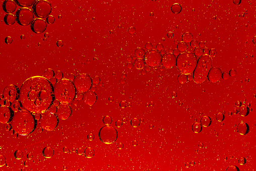 Macro red bubble texture close-up,red macro bubbles,Backgrounds, Abstract Backgrounds, Soda, Red, Carbonated,Beauty concept background. Closeup cosmetic liquid gel with bubbles on red colors background
