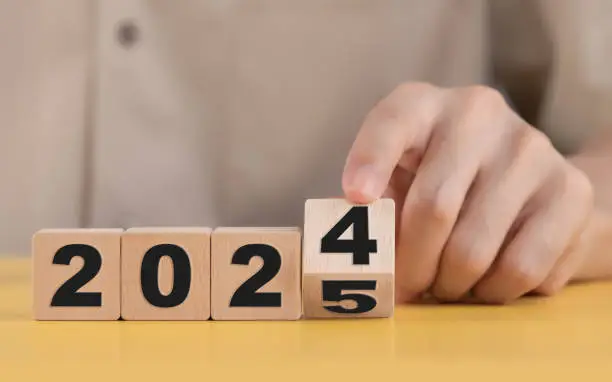 Photo of Business plan and countdown to 2025, The hand changing 2024 to 2025 on wooden cubes, Starting new business target strategy concept, Prepare to enter the new year.