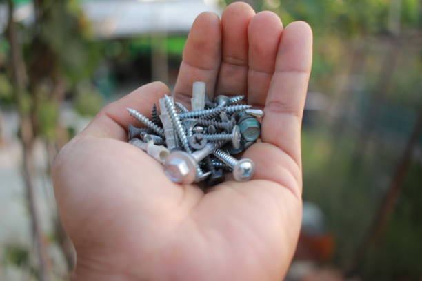 steel nut and screw in hand