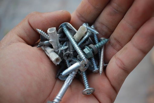 Top view of Many nuts and bolts on wood background and copy space