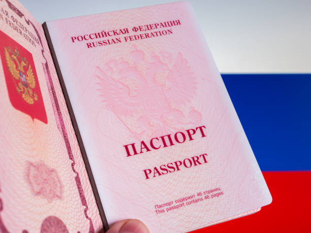 istock Russian Passport Held in Front of Flag 2019064223